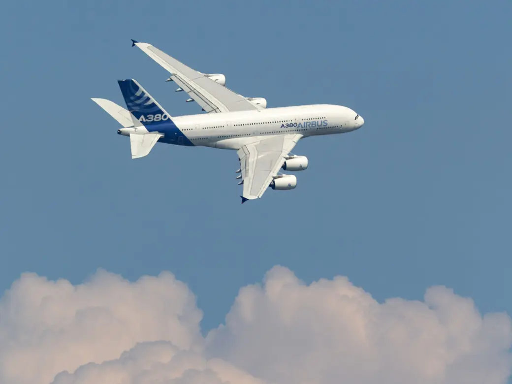 Airbus above clouds in front of a blue sky