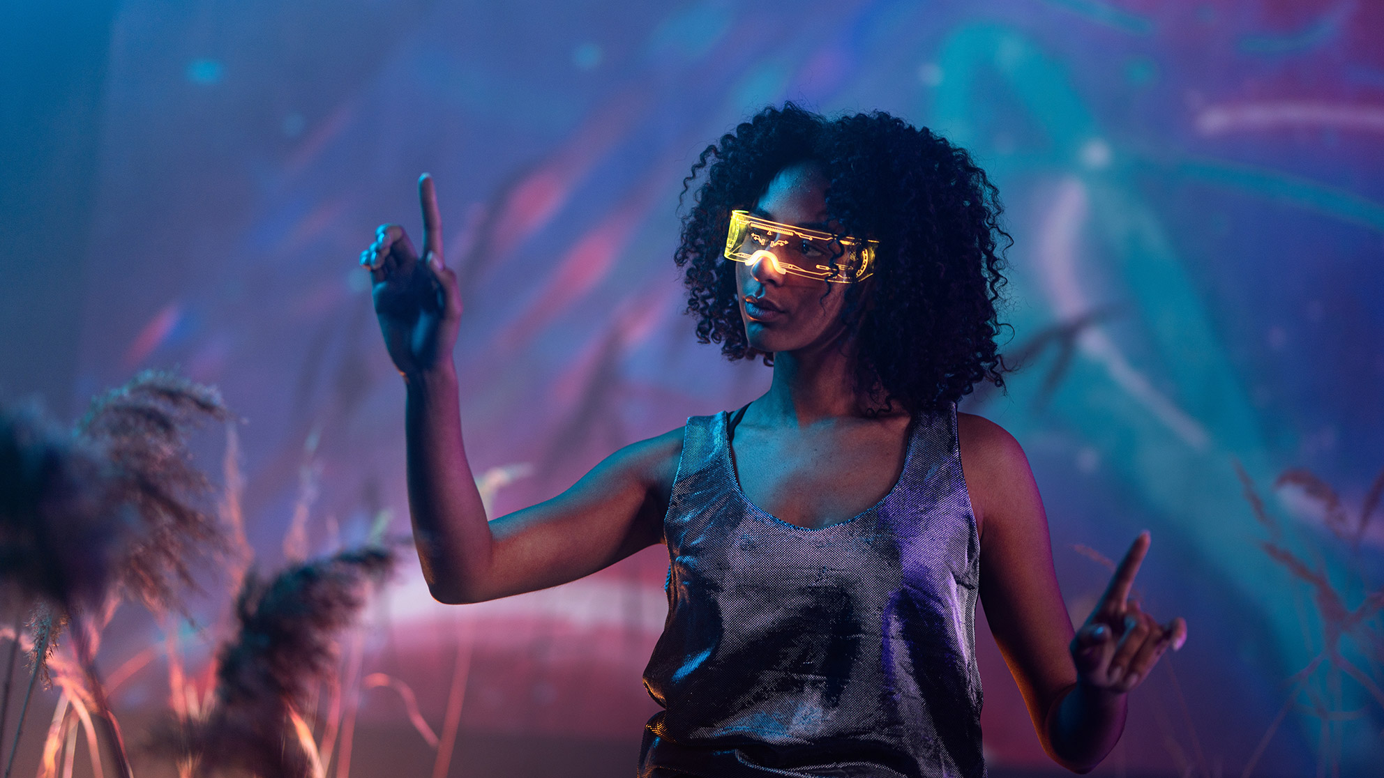 Woman with smart glasses against a purple futuristic background selects virtual things in the air